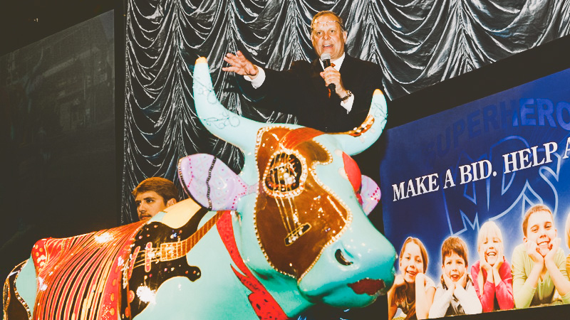 An auction of a fiberglass cow