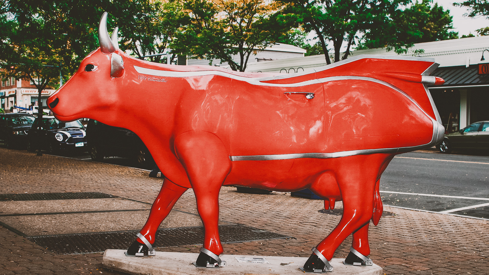 A red fiberglass cow designed like a vintage cadillac