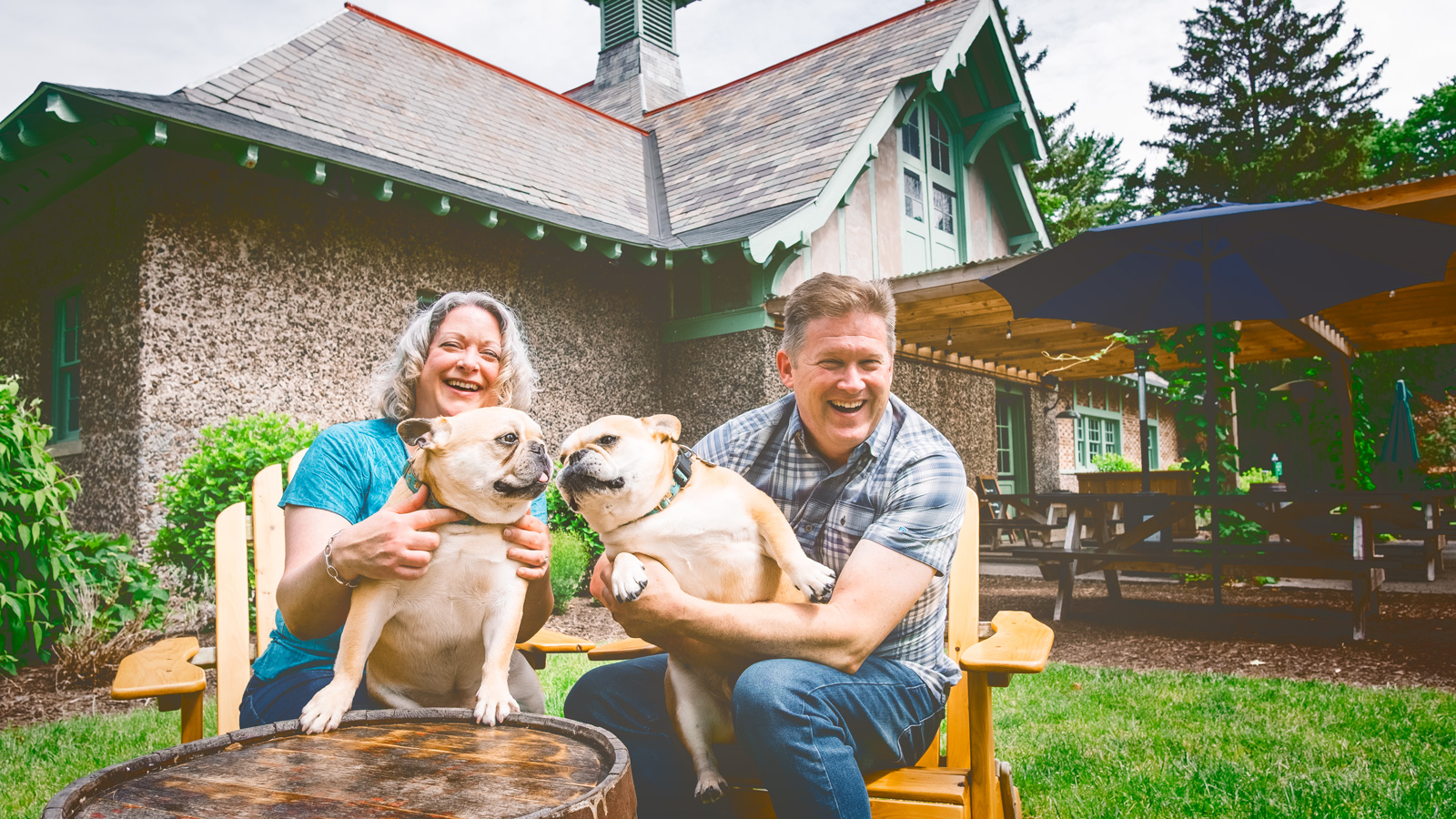 Stacey Girard Edinger ’95 and Derek Edinger ’94, MEng ’95, share a moment with Barley and Hops outside the restored sheep barn at Brewery Ardennes in Geneva