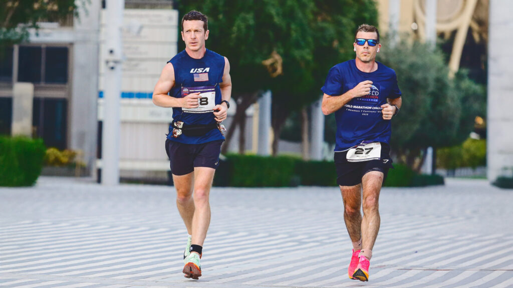 Alan Nawoj runs next to another competitor during the race in Dubai.