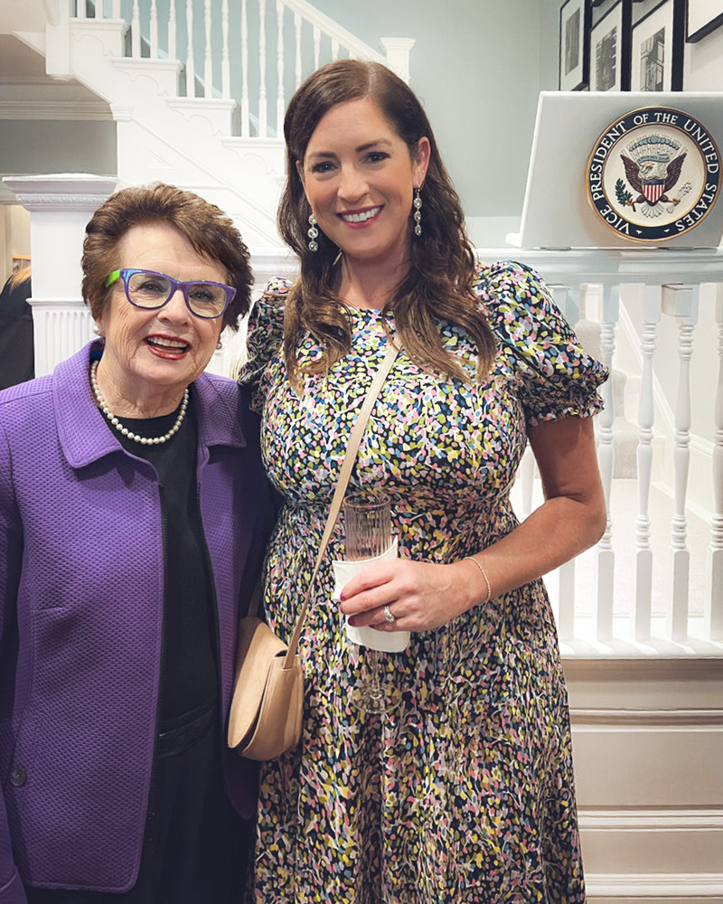 Sarah Spain smiles and poses for a picture next to Billie Jean King.