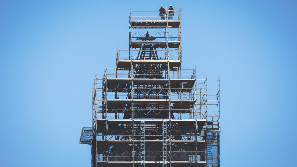 just the steel support structure of the McGraw Tower roof is visible through the surrounding scaffolding in this image taken during renovations