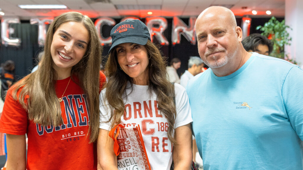 a student and her parents pose for a photo during Move-In Weekend, 2025