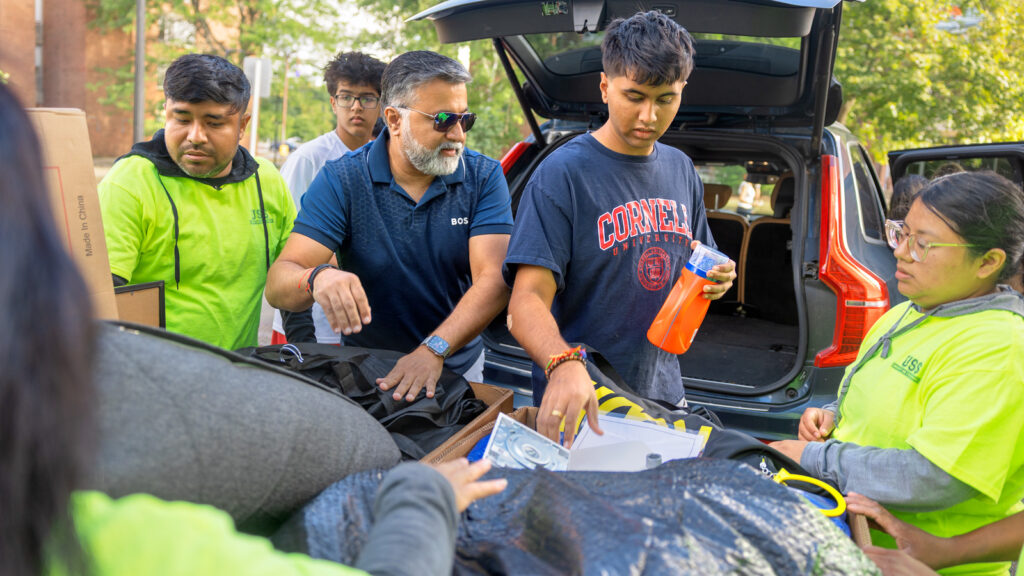 a student and family members unpack their car during Move-In Weekend, 2025