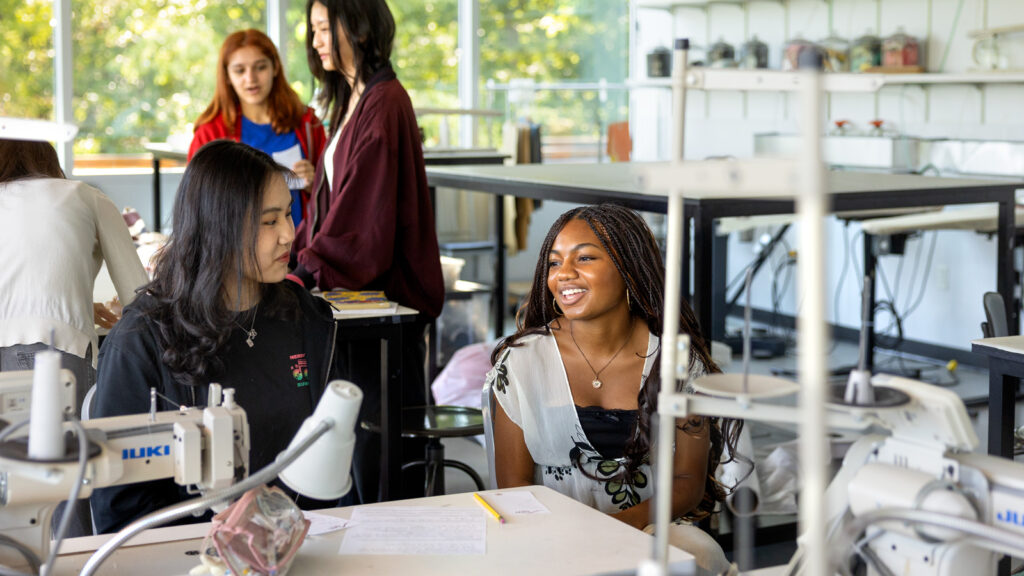Students chat in a lab on the first day of classes, fall 2025