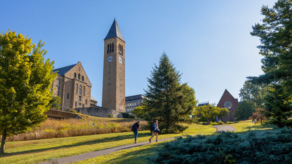 Two students walk up the Slope near the clocktower