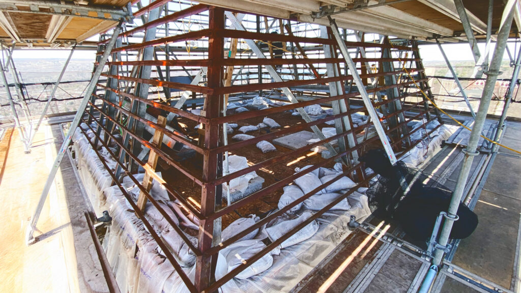 view of the the steel support structure of the tower roof before it was cleaned and painted in preparation for the sheet lead installation