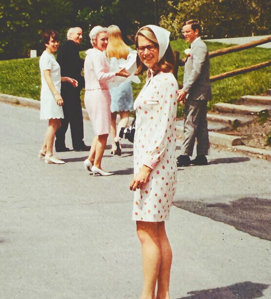 Margaret Higgins Bowker on the Hill during her time as a student wearing a white patterned dress.