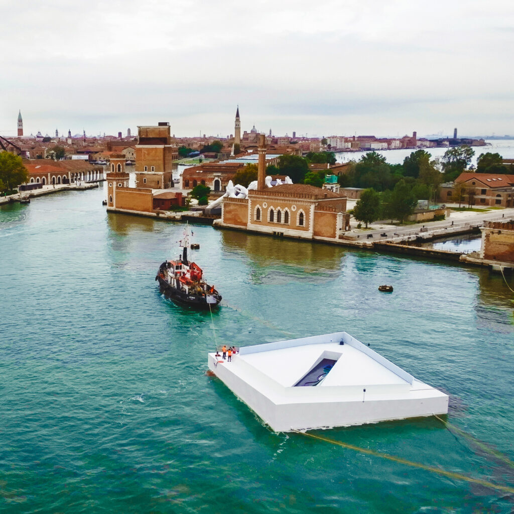 The AquaPraça exhibit is towed into a Venice canal