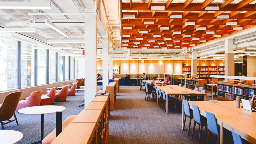 new study tables, seating, and shelving shown in the renovated main floor of Olin Library