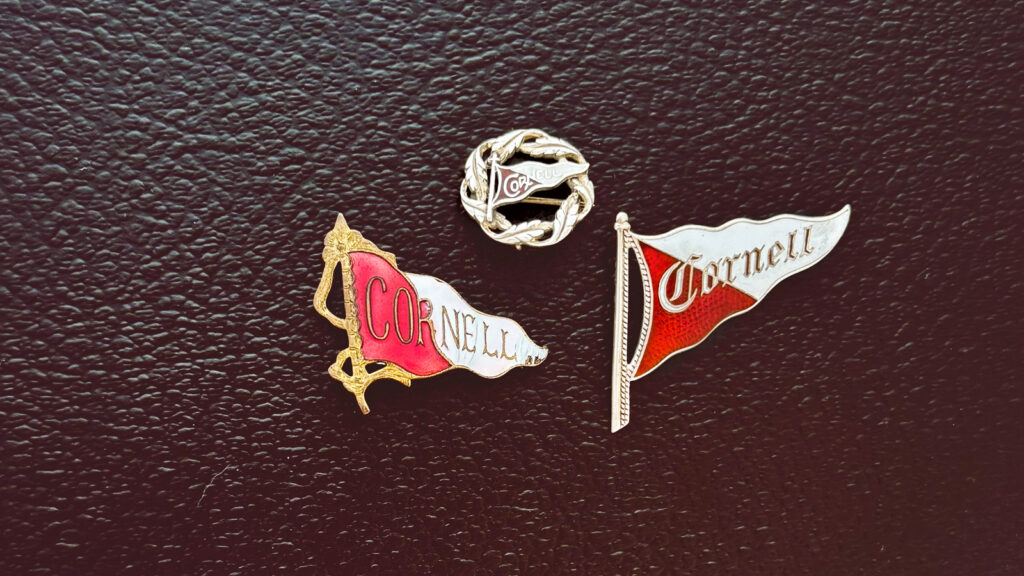 Three small enameled Cornell pennant pins from Kate Costa Leming's collection