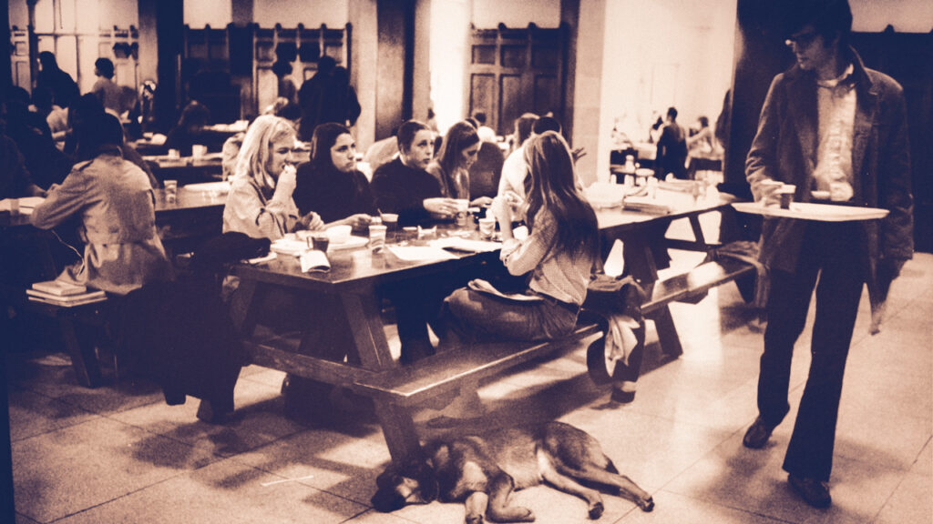 students and a dog hang out in the Ivy Room in Willard Straight Hall, 1970s
