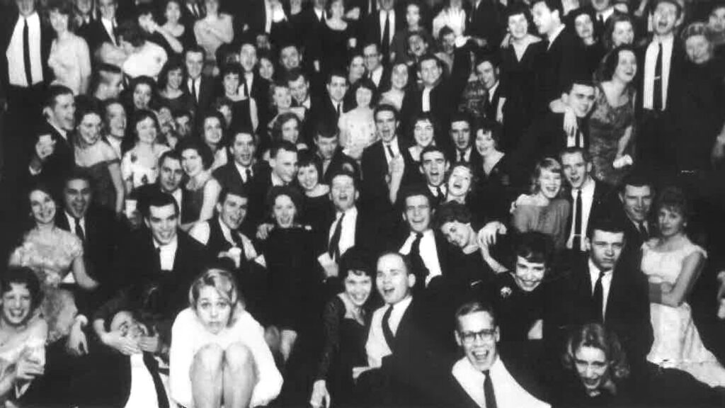 Peter Meinig ’61, BME ’62, and Nancy Schlegel Meinig ’62, are pictured in the center of this group photo as students at a Phi Gamma Delta event in spring 1961