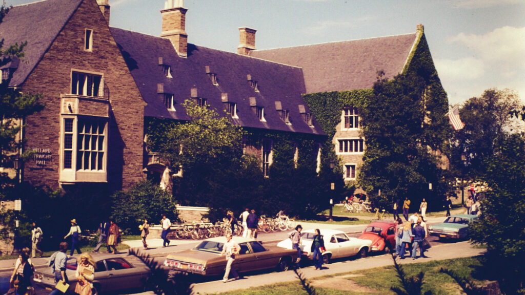 cars and pedestrians along the street in front of Willard Straight Hall, 1974