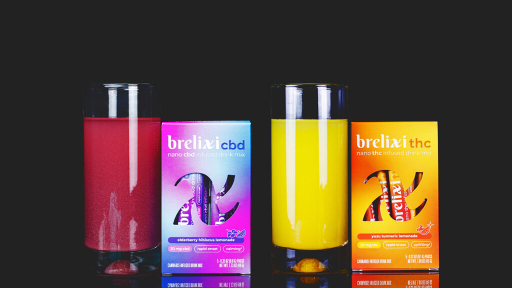 Brelixi's blue and purple and orange and yellow powder drink mix products with a glass of purple and yellow juice next to them.