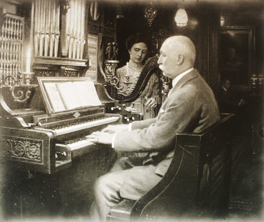Miller, an accomplished organist, is pictured in his later years playing the organ at his home in Ithaca with his daughter playing the harp behind him