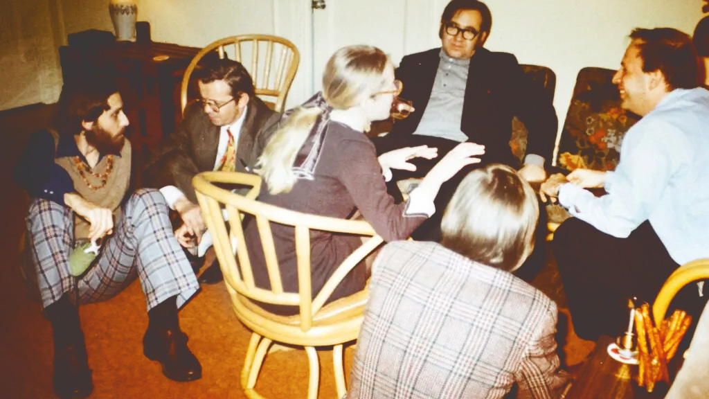 Claudia Goldin speaking with a room full of male economists while a grad student at the University of Chicago