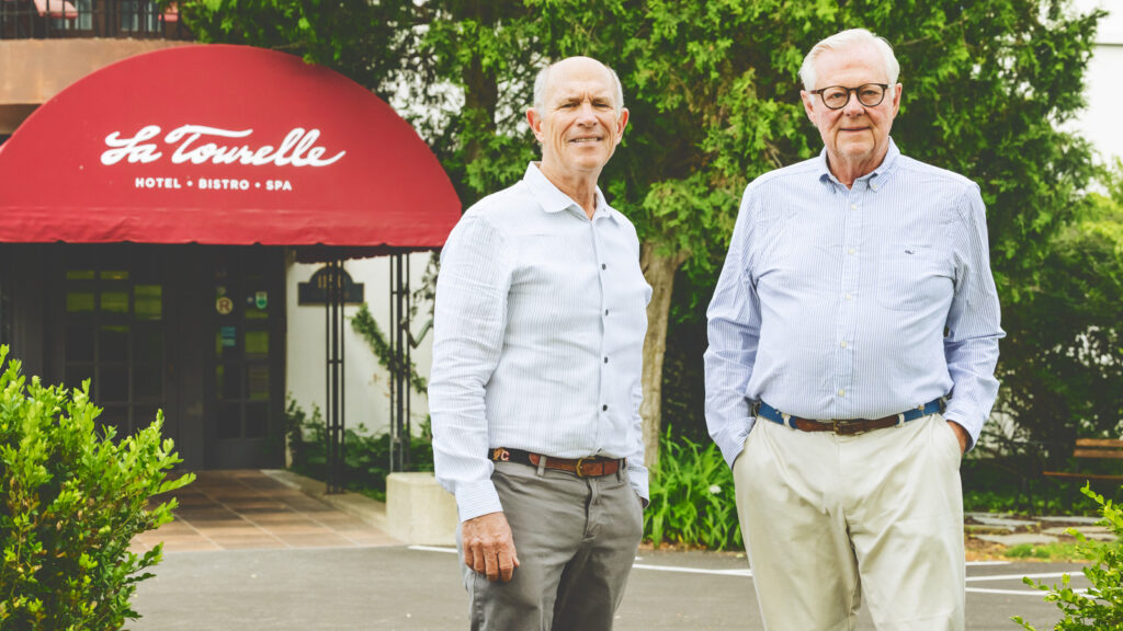 Cornell alums Bill Minnock (left) and Joe Lavin pose for a portrait on the grounds of La Tourelle Hotel and Spa