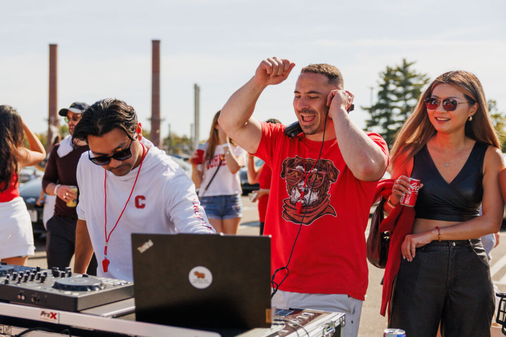 The DJ's for homecoming smile and look at their equipment.