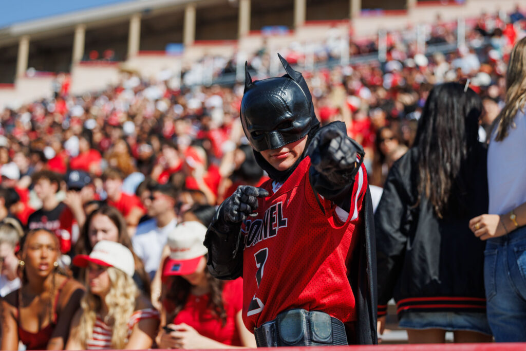 A Big Red fan is dressed as Batman.