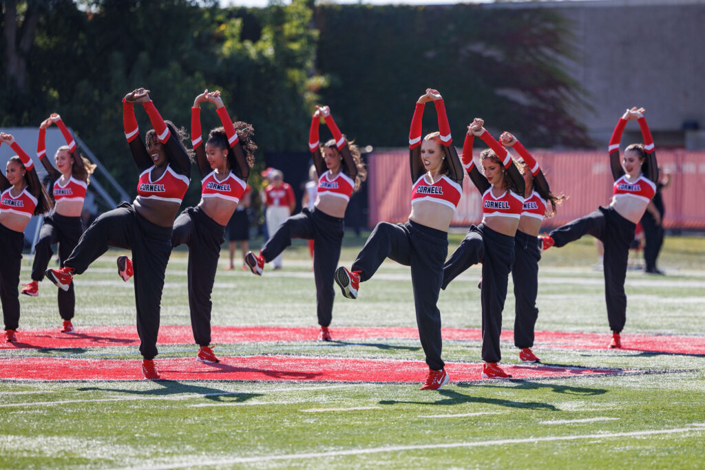 The Cornell Dance Team performs a routine on the field during the homecoming game.