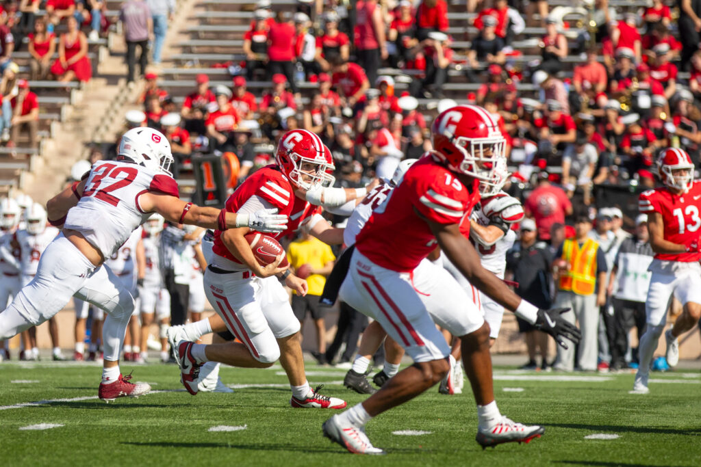 A close up shot of Cornell football players in action during the homecoming game.