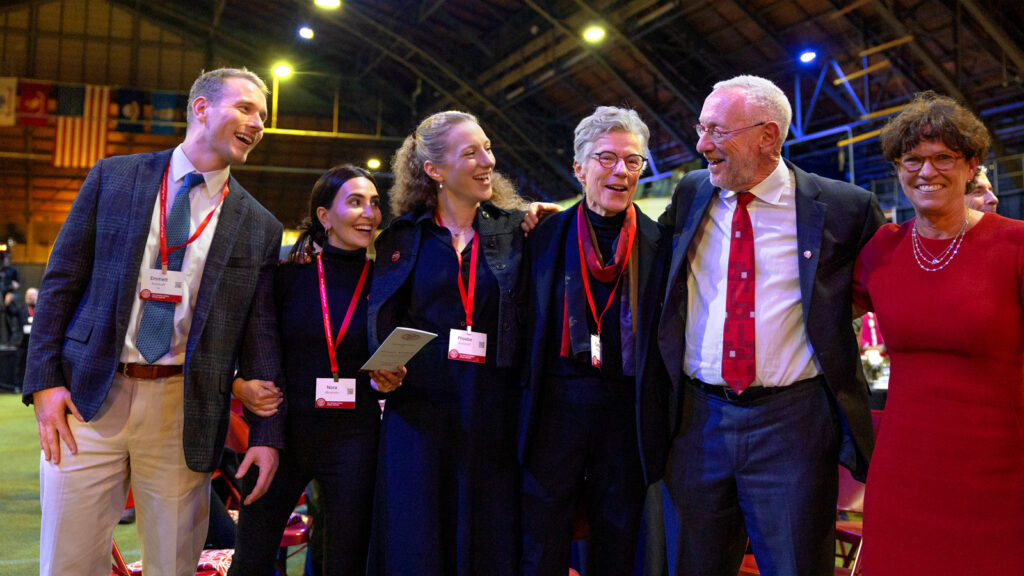 President Michael Kotlikoff, second from right, sings the alma mater with members of his family and Board of Trustees Chair Anne Meinig Smalling ’87, right, following his inauguration as Cornell University's 15th president