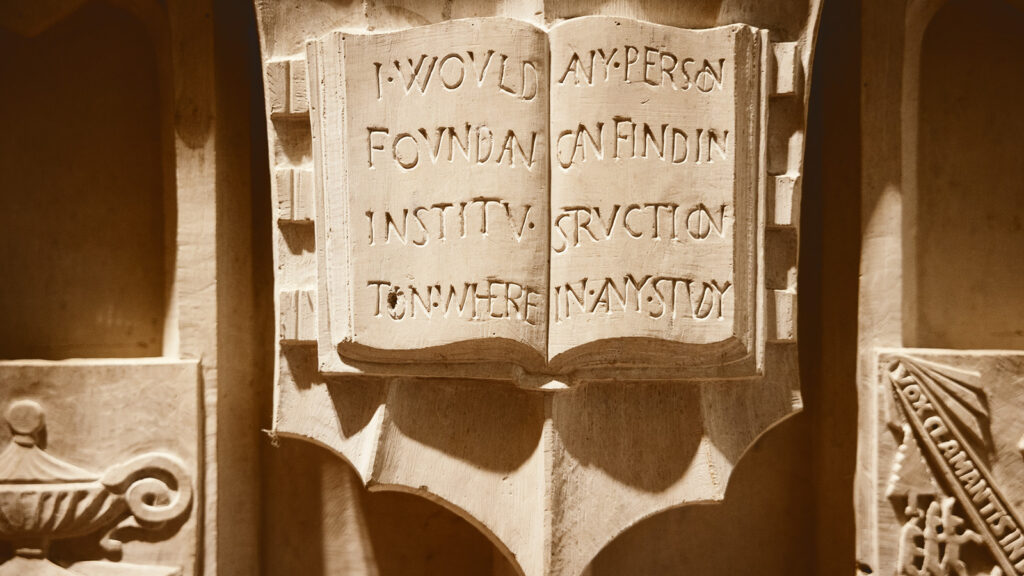 detail on Ezra Cornell's sarcophagus includes the "Any person ... any study" founding principle on a carved tablet