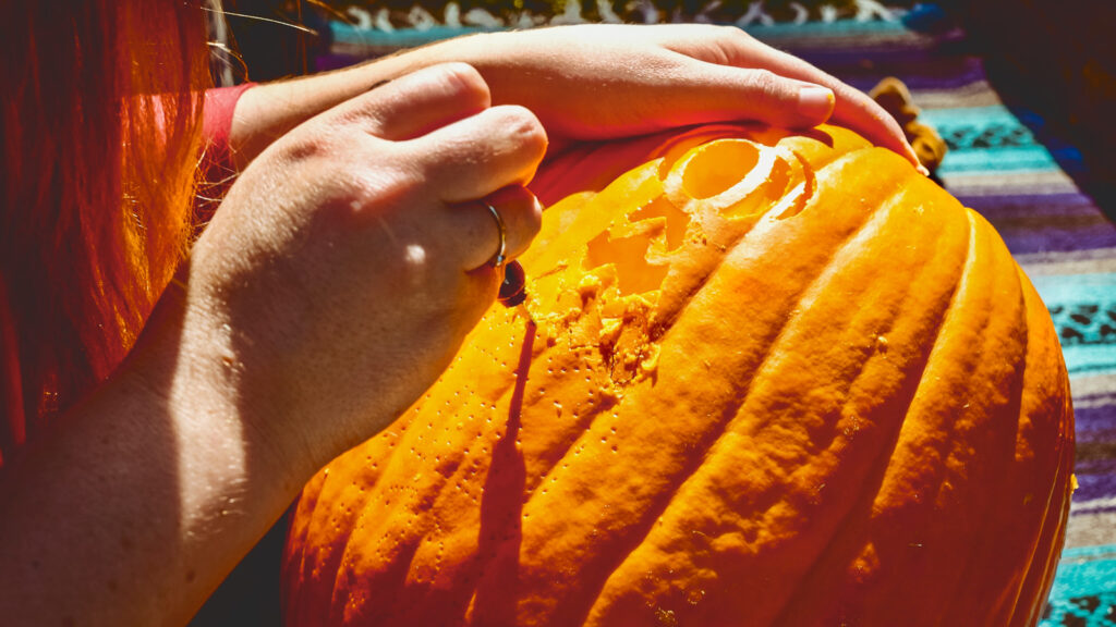closeup detail of a pumpkin being carved