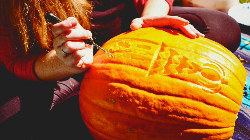 closeup of pumpkin being carved
