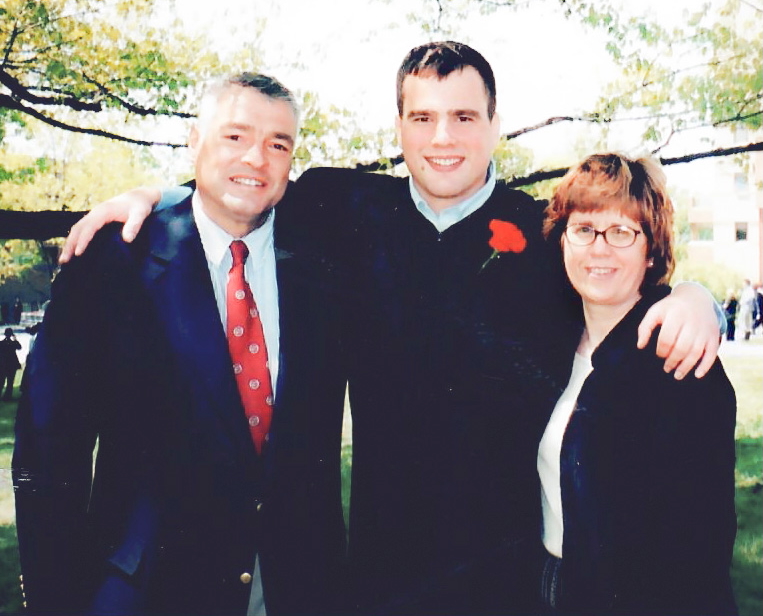 Jason Moore with his parents during his commencement.