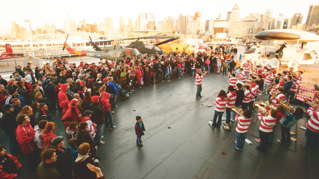 The Big Red Pep Band plays on the deck of the USS Intrepid in 2009 prior to the Red Hot Hockey game at Madison Square Garden