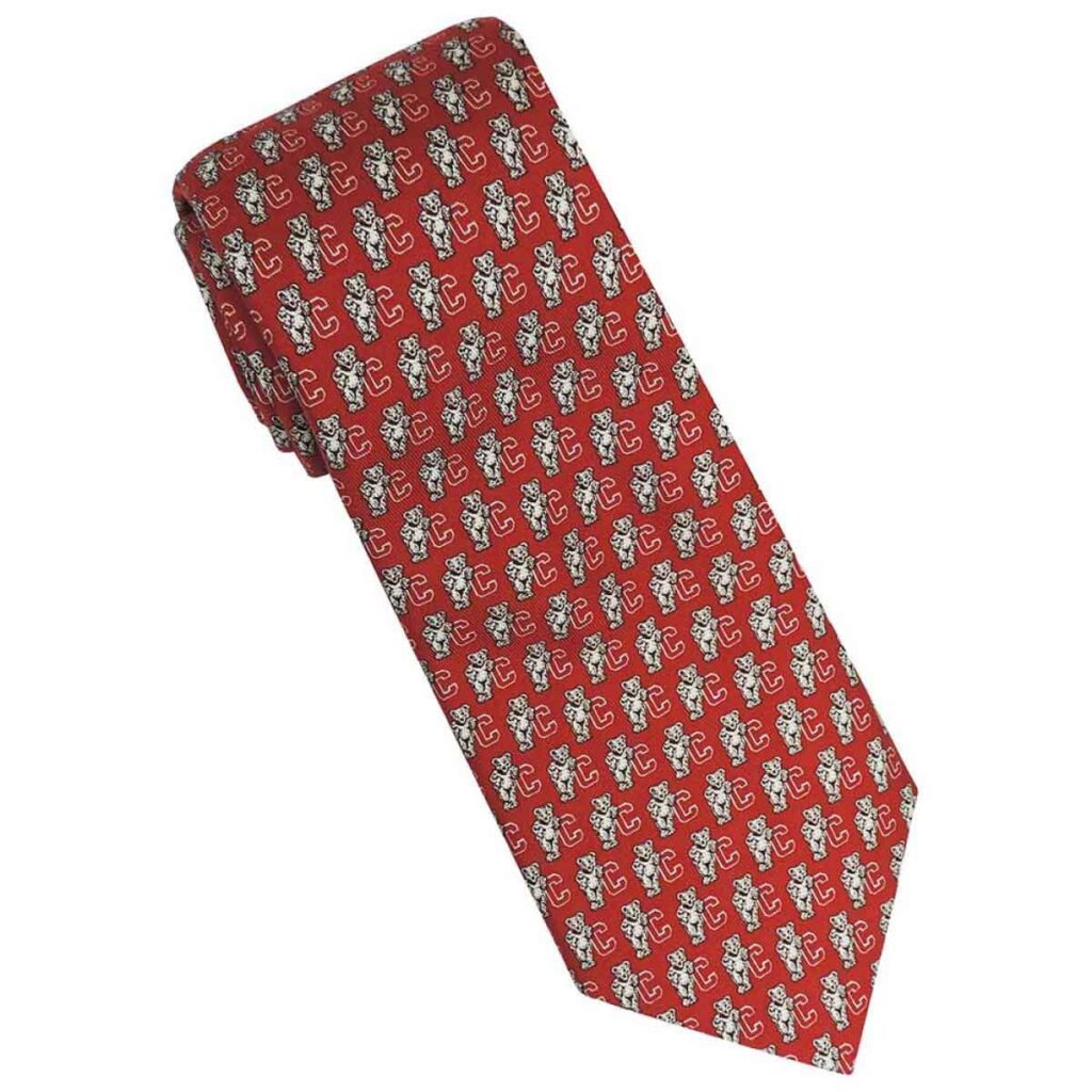 A red tie with the Cornell bear logo printed in a small repeating pattern on it.