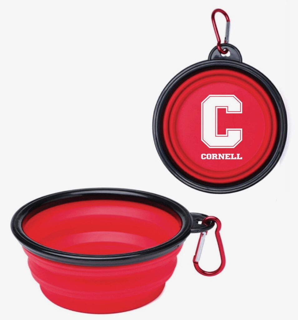 A red reusable, pop-out dog bowl on a carabiner with the Cornell logo on it.