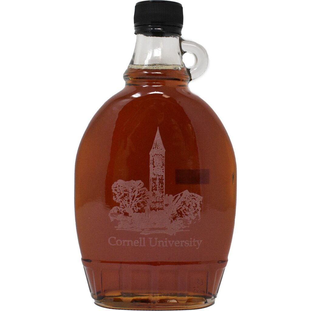 A bottle of maple syrup with McGraw Tower printed on the front and writing that says "Cornell University."