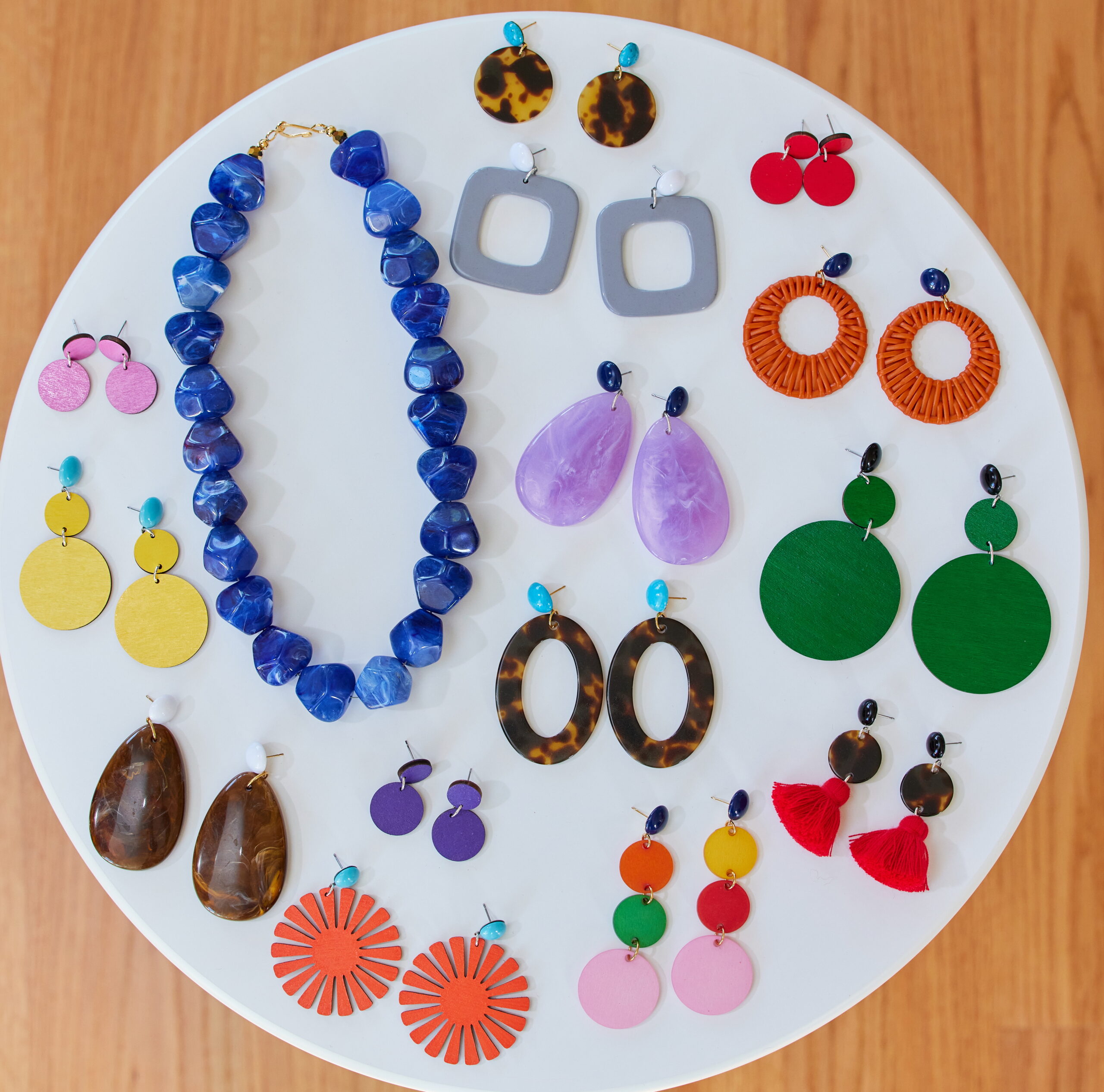 A collection of colorful earrings and a necklace