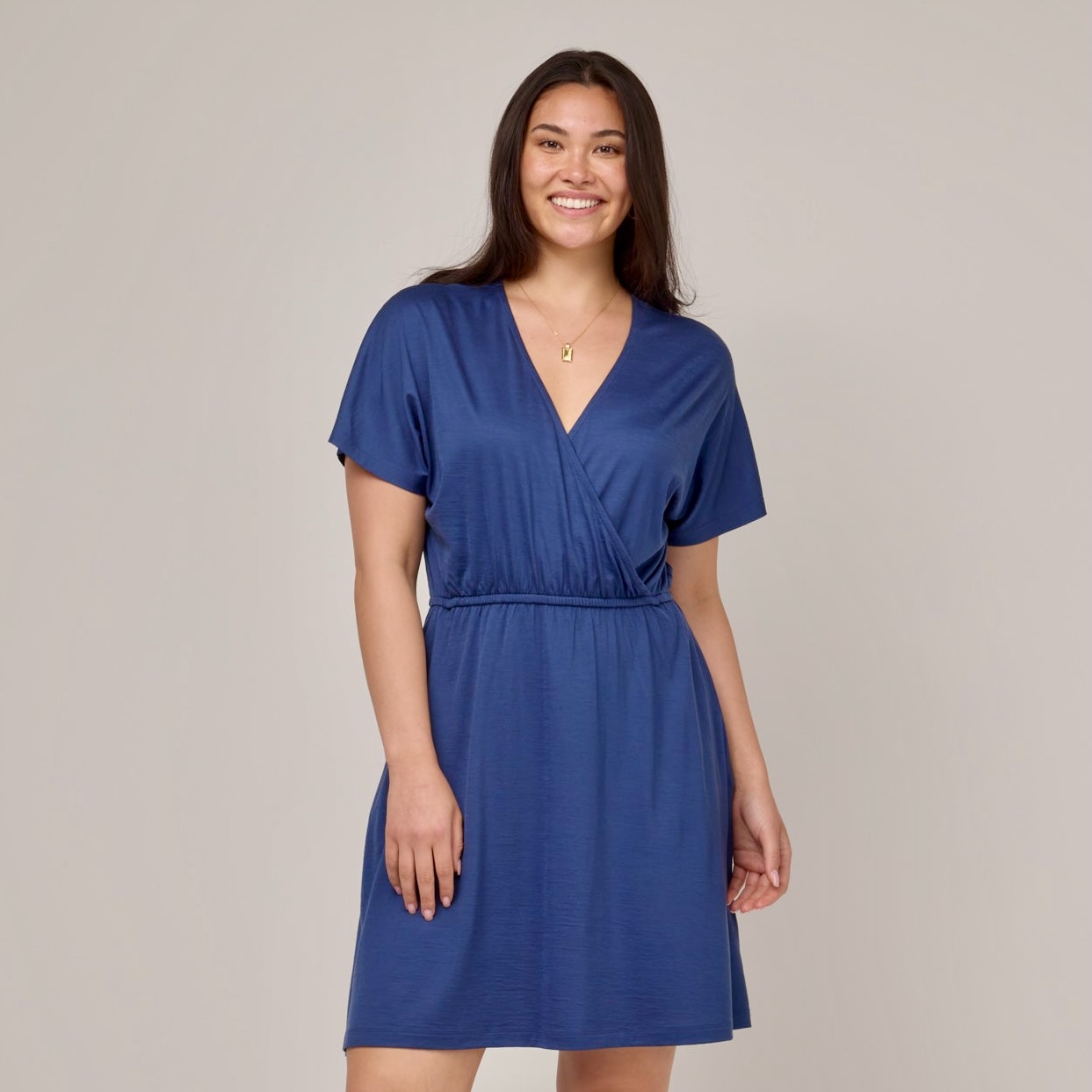 A model in a blue dress with short sleeves