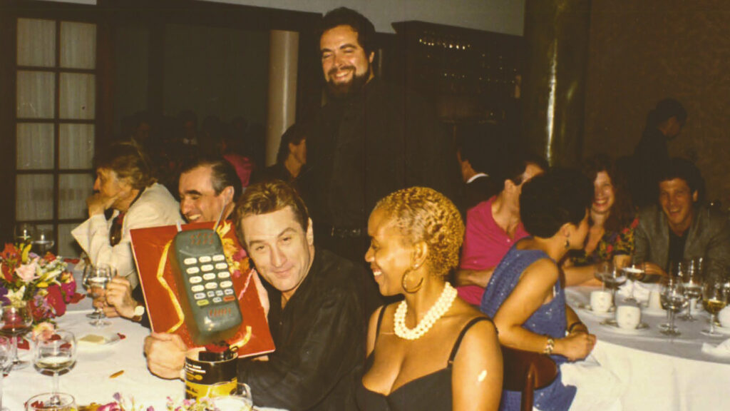 Drew Nieporent stands behind Robert De Niro at Montrachet