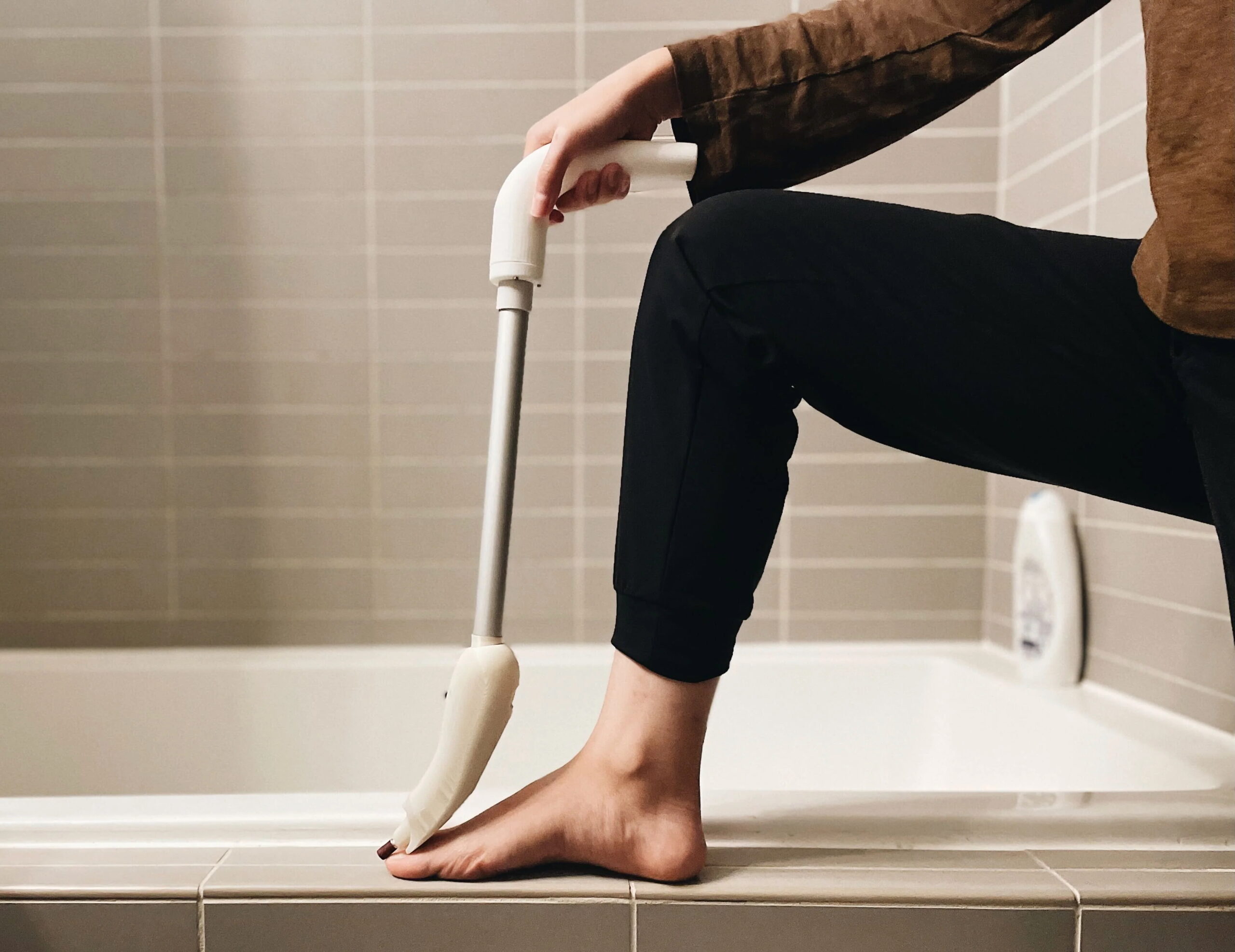 A person using a long-handled toenail trimmer