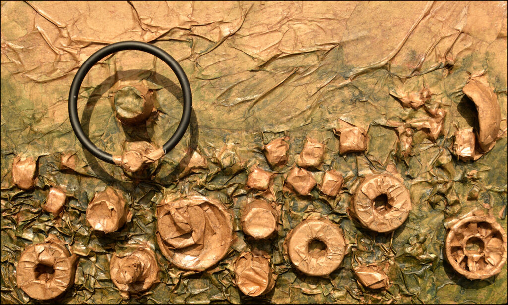 An art piece from AbandonmenTissues that is green and brown textured paper covering different circular items and a black ring protruding from the canvas.