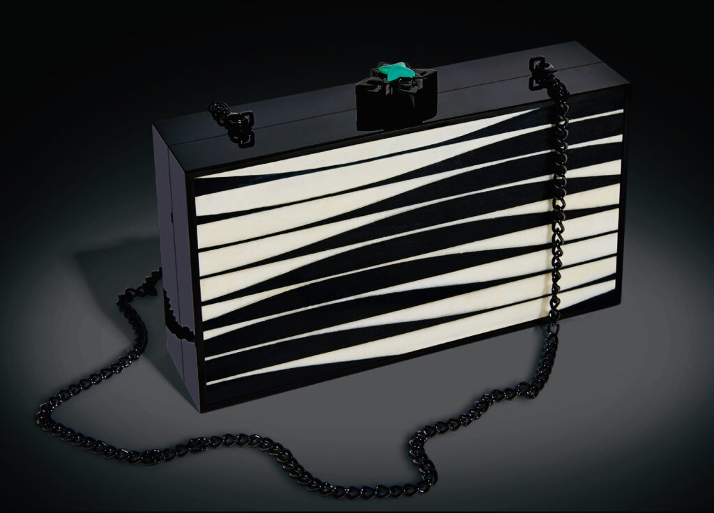 A clutch purse with black and white inlays