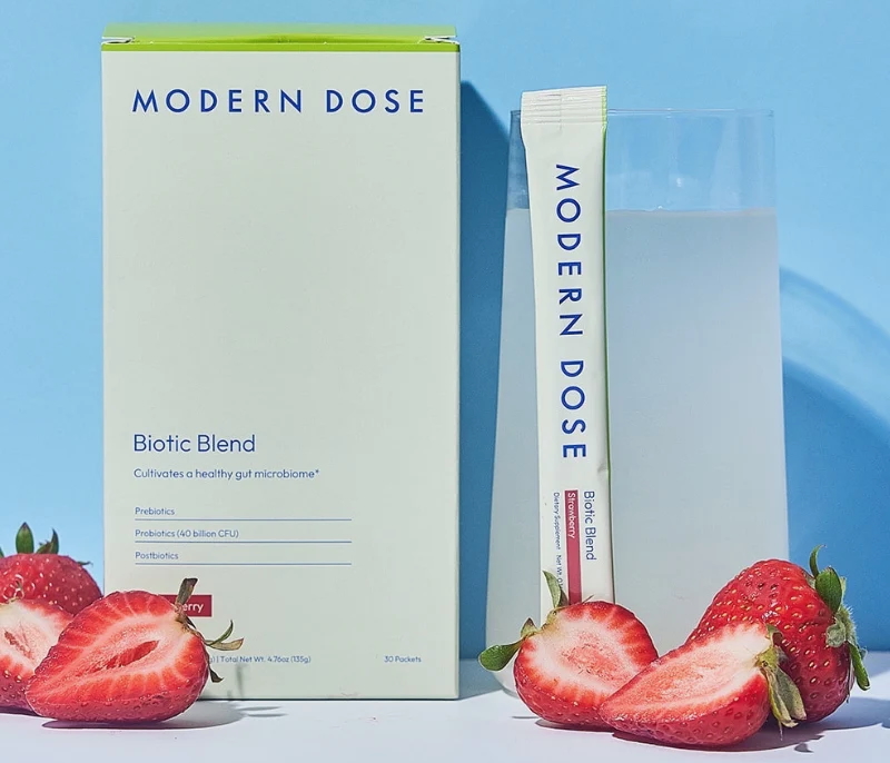 A box of Modern Dose products with a packet and strawberries