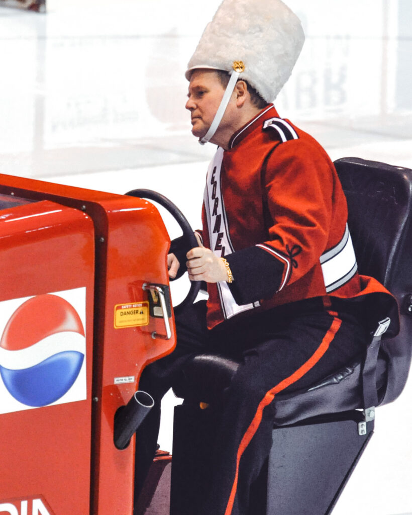 Dave Nulle driving an ice resurfacer at Lynah Rink, dressed as Big Red band leader