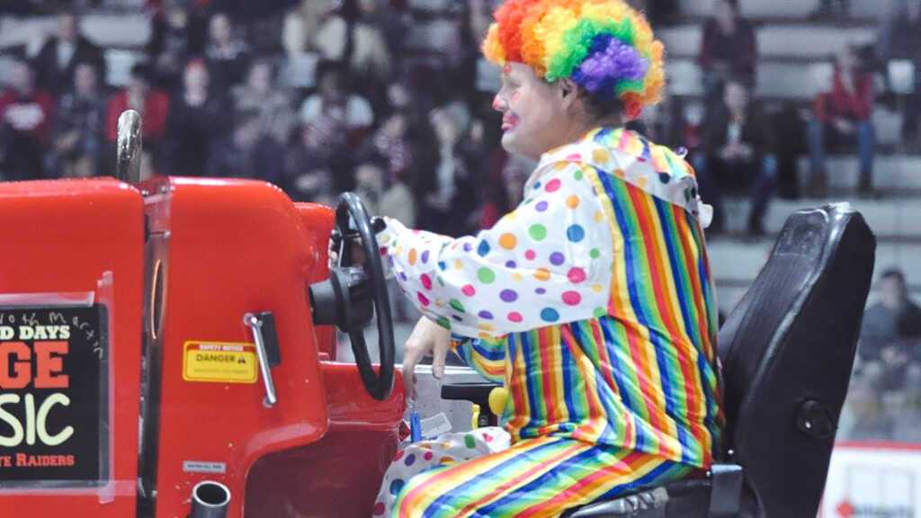 Dave Nulle driving an ice resurfacer at Lynah Rink, dressed as a circus clown
