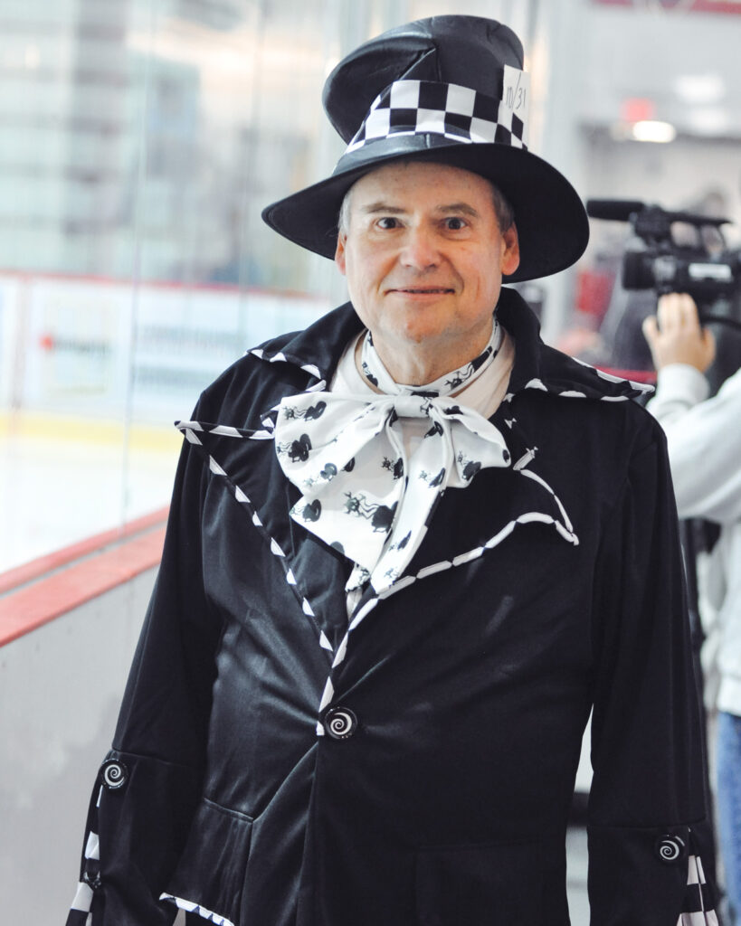Dave Nulle at Lynah Rink, dressed in a top hat and coat with a Day of the Dead theme