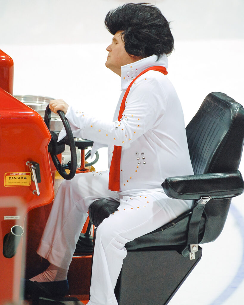 Dave Nulle driving an ice resurfacer at Lynah Rink, dressed as Elvis