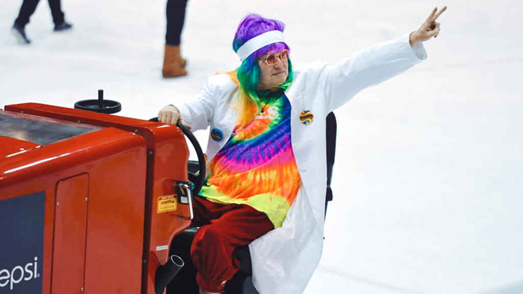 Dave Nulle driving an ice resurfacer at Lynah Rink, dressed as a hippie