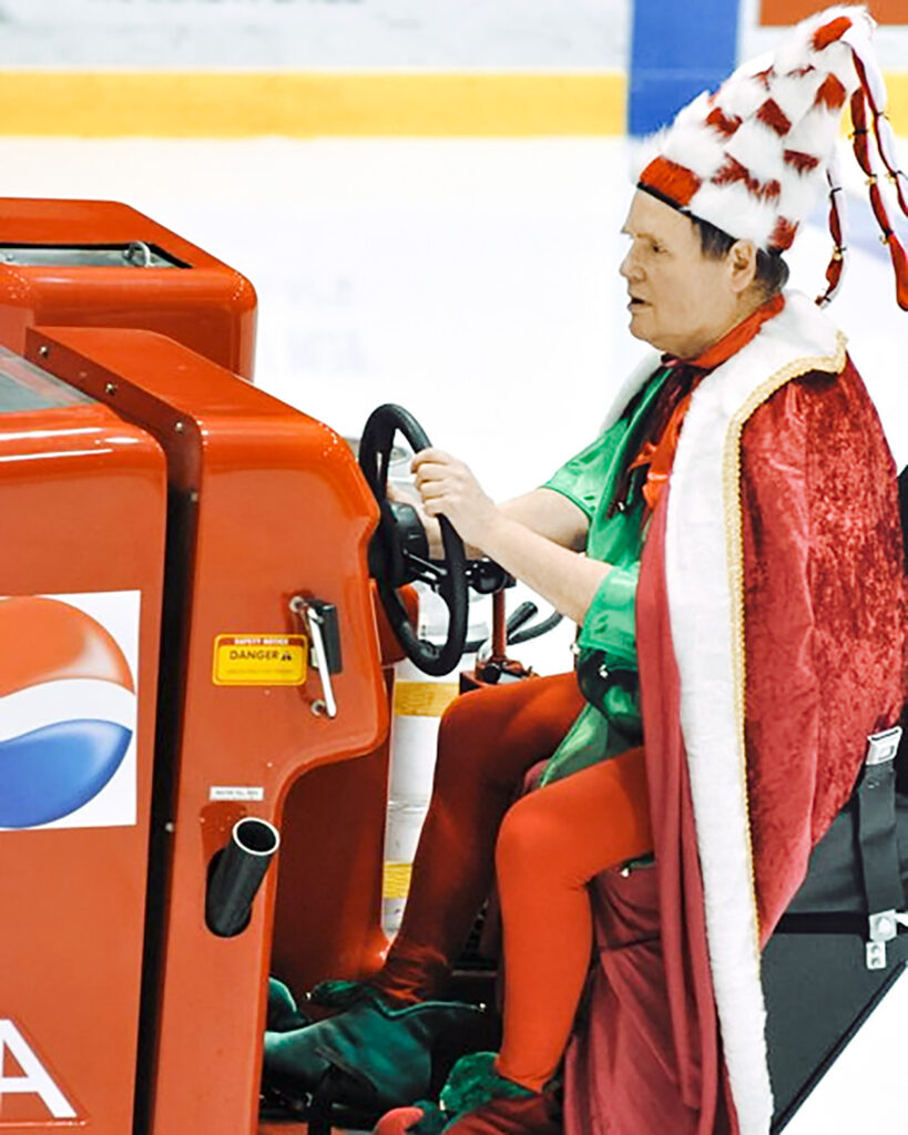 Dave Nulle driving an ice resurfacer at Lynah Rink, dressed as an elf