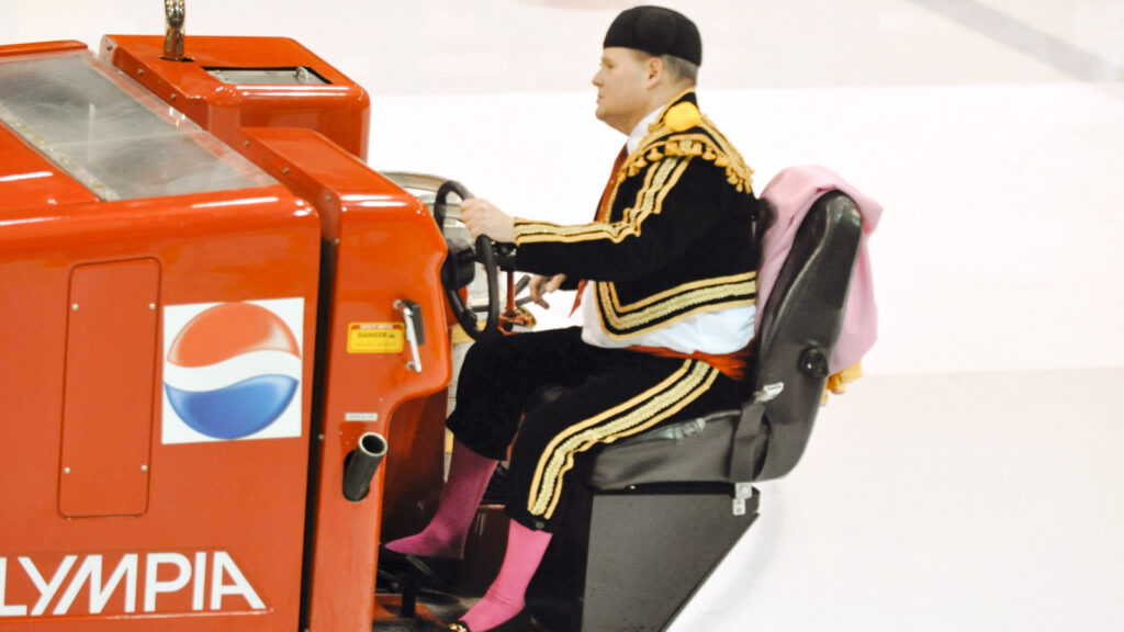Dave Nulle driving an ice resurfacer at Lynah Rink, dressed as a bullfighter