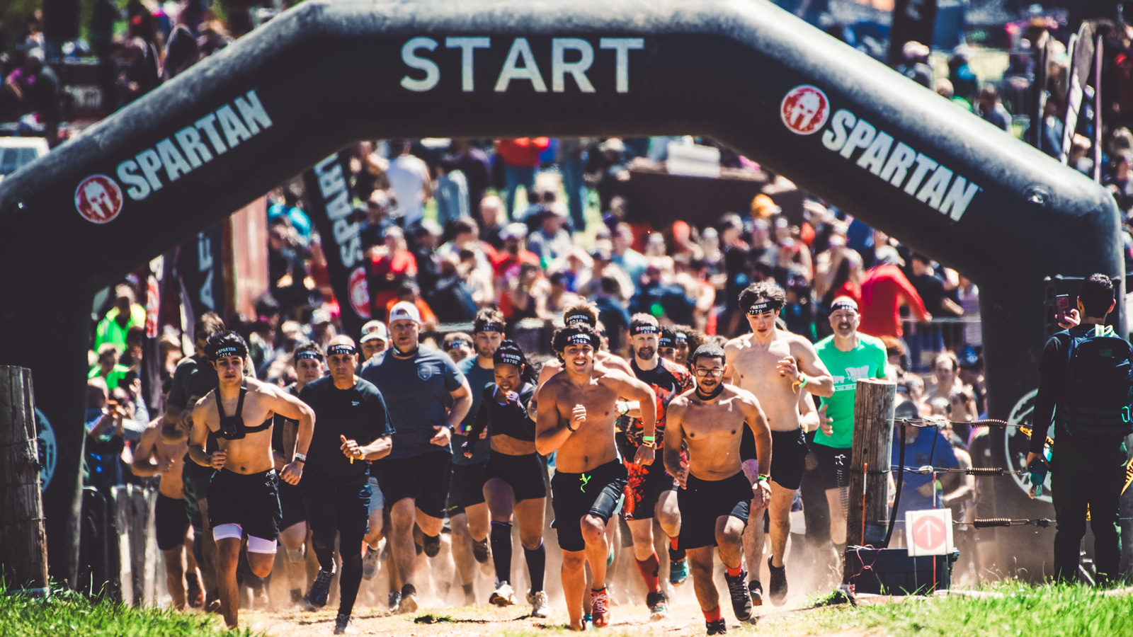 Participants running at the start of the Spartan race.